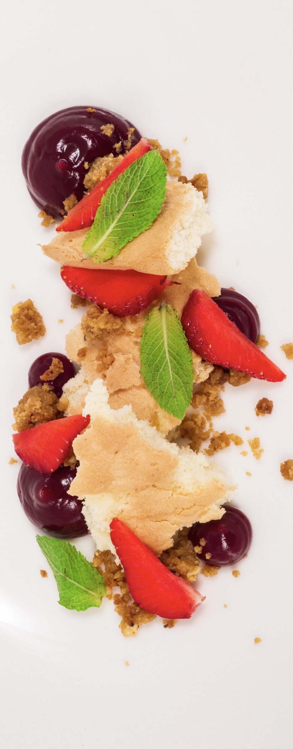 Strawberry, meringue and berry dessert captured from above